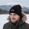 Yurap Designs black beanie with embroidered logo worn outdoors in winter