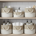 Woven fabric storage baskets on bathroom shelves