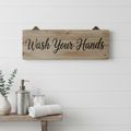 Rustic wooden bathroom sign on white wall