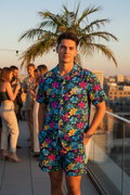 Man wearing Paradise Nights short set at rooftop party