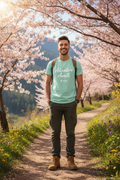 Man wearing Adventure Awaits tee hiking on spring trail