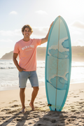 Man wearing Wild & Free tee at the beach