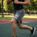 Yurap Designs grey athletic shorts with logo worn by model exercising