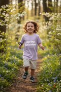 Child wearing Spring Adventurer tee exploring forest trail
