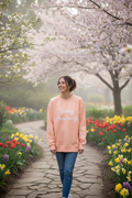Model wearing Spring Awakening crewneck in spring garden